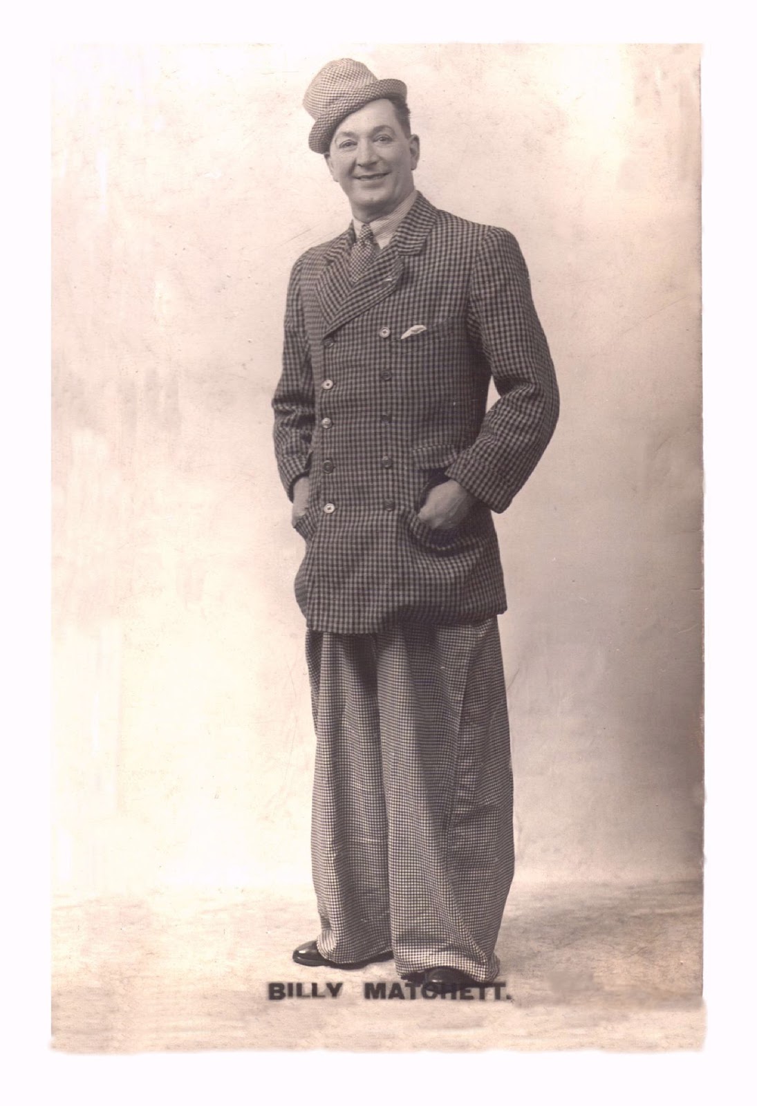 Billy Matchett publicity postcard: full length in a loud checked suit and matching trilby hat